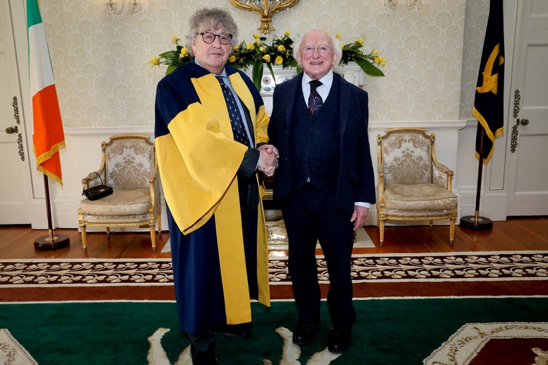 President Michael D Higgins shakes the hand of Ireland Chair of Poetry Paul Muldoon in Áras an Uachtaráin