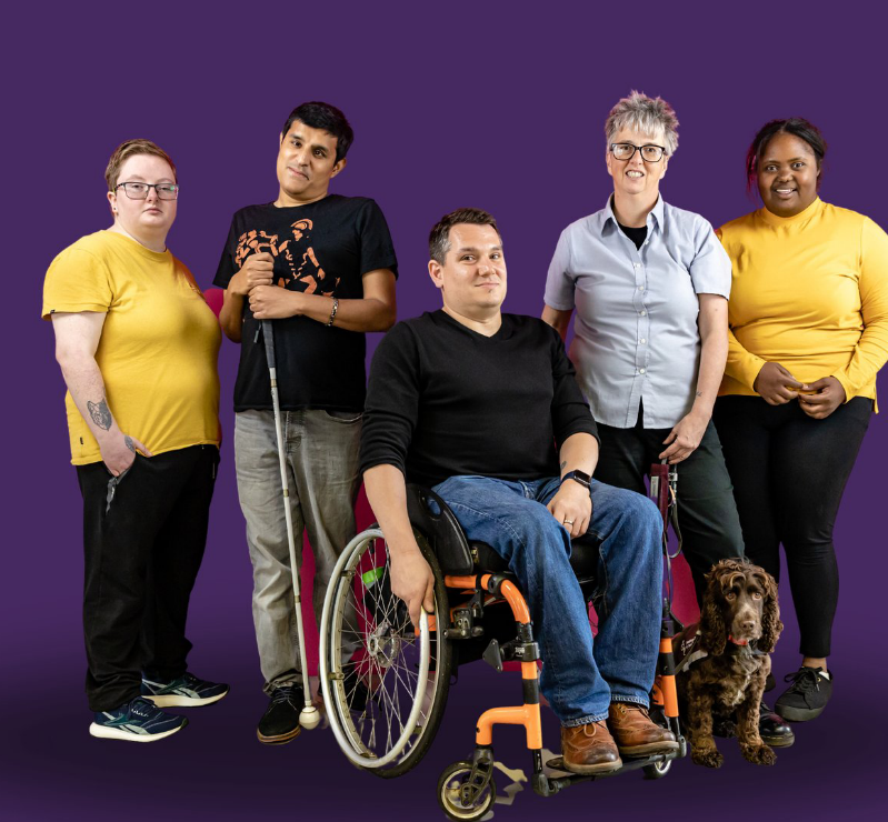 Five individuals with different disabilities pose in a line and smile at the viewer